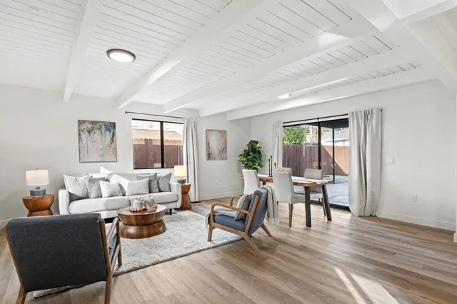 a dining room with furniture and wooden floor