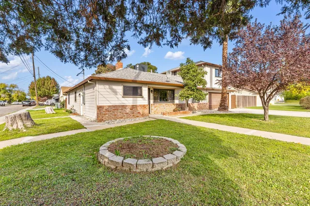 a view of a white house with a swimming pool