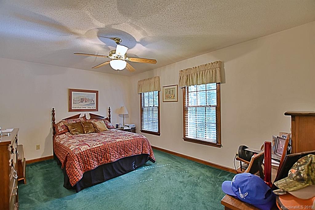 3550 Dobys Bridge Road Fort Mill, SC 29715 - Photo 15 of 48 a bedroom with a bed and a chandelier