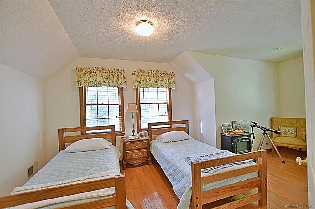 3550 Dobys Bridge Road Fort Mill, SC 29715 - Photo 21 of 48 a bedroom with a bed and wooden floor