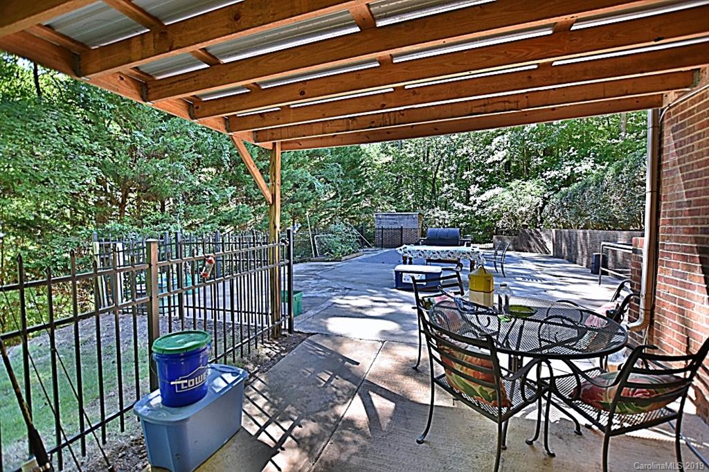 3550 Dobys Bridge Road Fort Mill, SC 29715 - Photo 23 of 48 a view of a chairs and table in the back yard of the house
