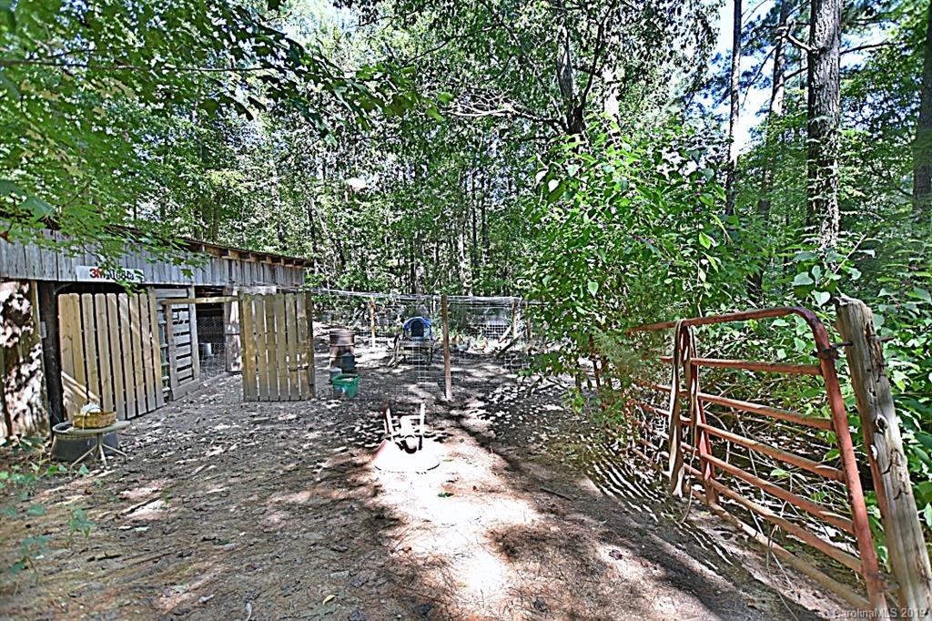 3550 Dobys Bridge Road Fort Mill, SC 29715 - Photo 29 of 48 a view of backyard with wooden fence and large trees