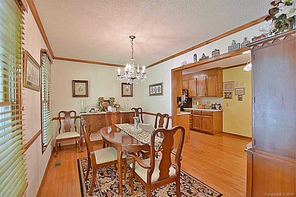 3550 Dobys Bridge Road Fort Mill, SC 29715 - Photo 4 of 48 a view of a dining room with furniture a chandelier and wooden floor