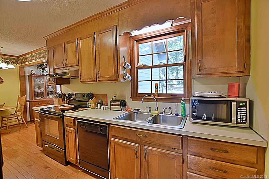3550 Dobys Bridge Road Fort Mill, SC 29715 - Photo 10 of 48 a kitchen with stainless steel appliances granite countertop a sink stove and cabinets