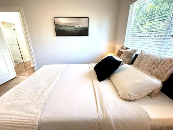 a bedroom with a bed and a large window