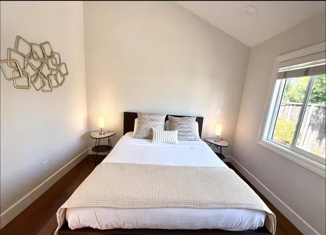 a bedroom with a bed and a window