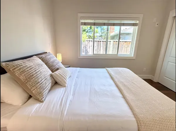 a bedroom with a bed and a window