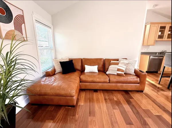 a living room with furniture and wooden floor