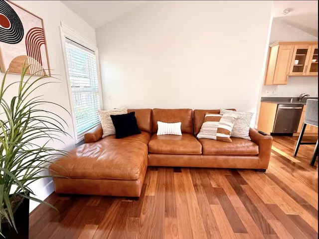 a living room with furniture and wooden floor