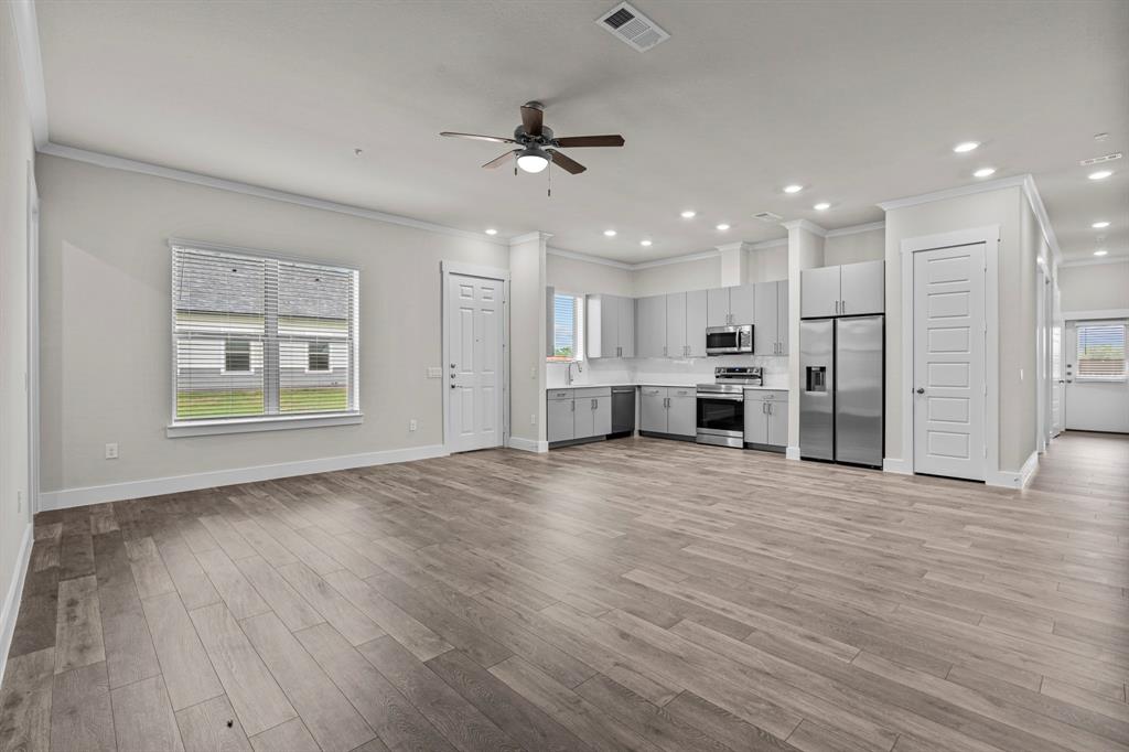 a view of kitchen with refrigerator and window