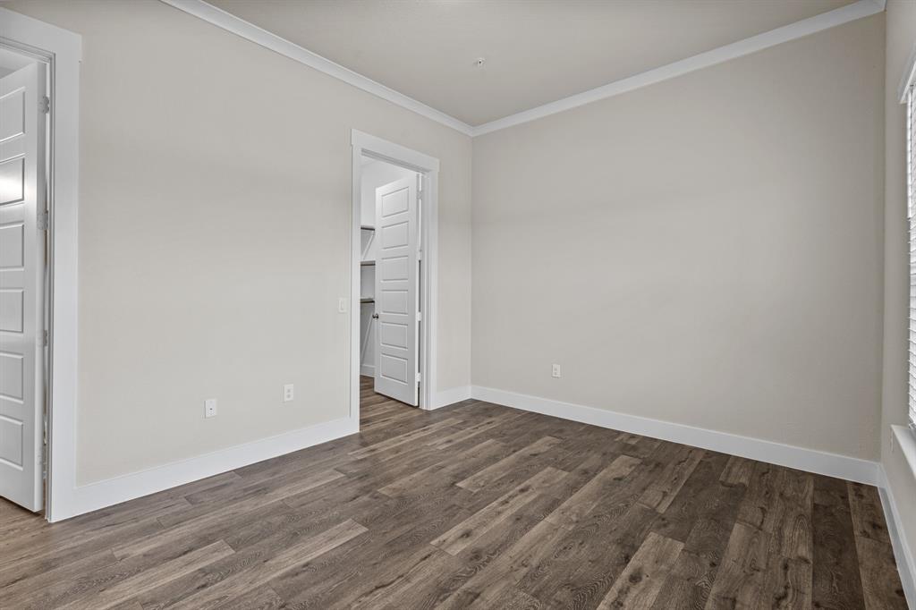 3281 Ganzer Road West, Unit 823A Denton, TX 76207 - Photo 13 of 40 a view of an empty room with wooden floor