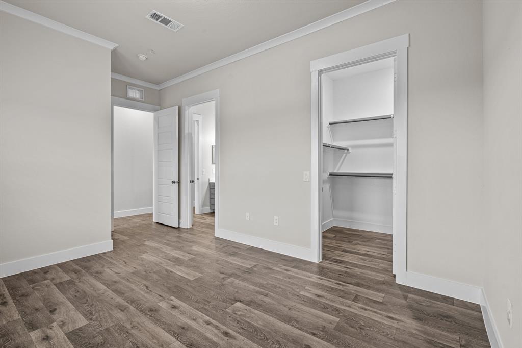 3281 Ganzer Road West, Unit 823A Denton, TX 76207 - Photo 14 of 40 a view of an empty room with wooden floor