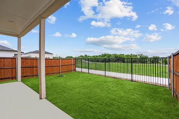 a view of backyard with hardwood and deck