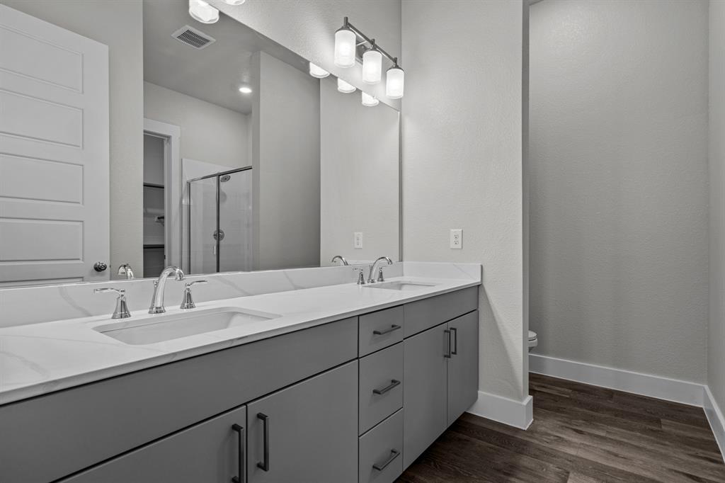 3281 Ganzer Road West, Unit 823A Denton, TX 76207 - Photo 25 of 40 a bathroom with a double vanity sink and a mirror