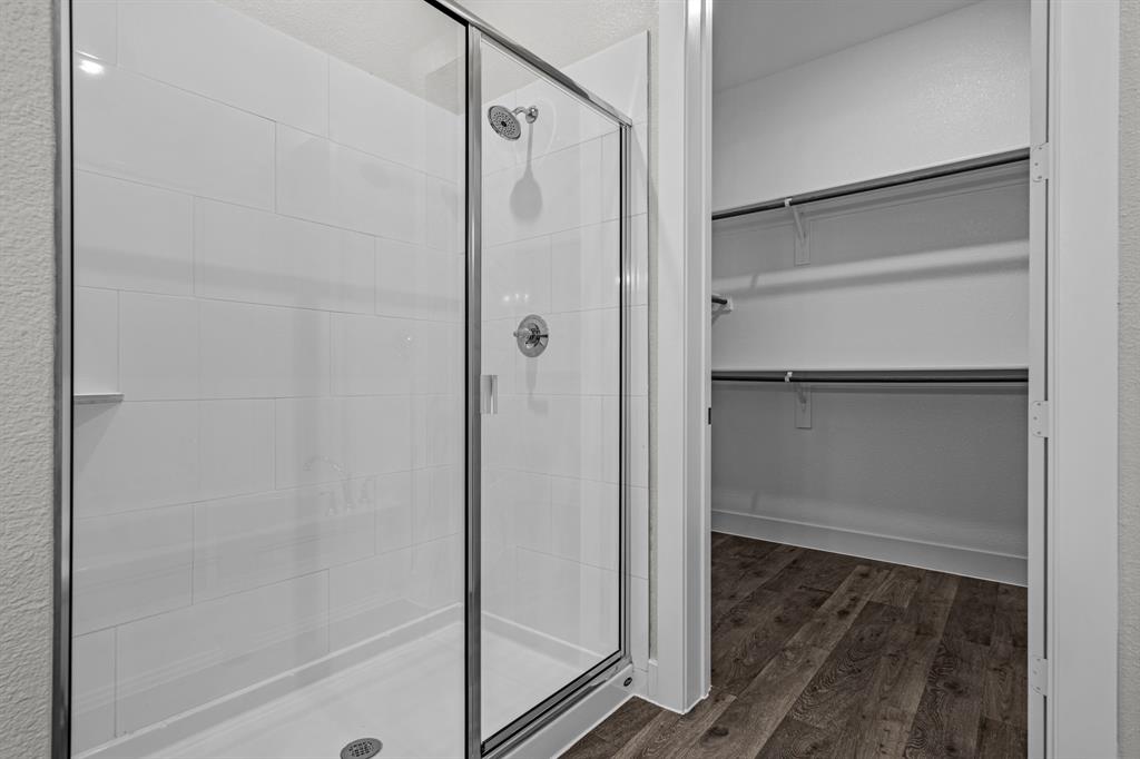 3281 Ganzer Road West, Unit 823A Denton, TX 76207 - Photo 26 of 40 a bathroom with a glass shower door