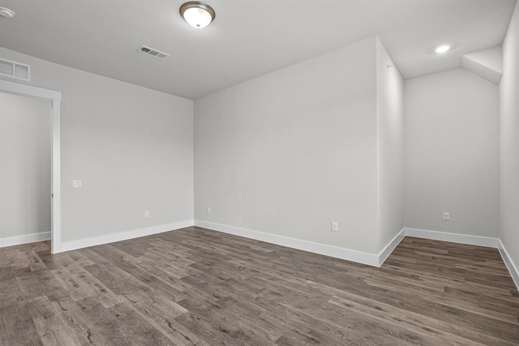 3281 Ganzer Road West, Unit 823A Denton, TX 76207 - Photo 32 of 40 a view of an empty room with wooden floor and a window