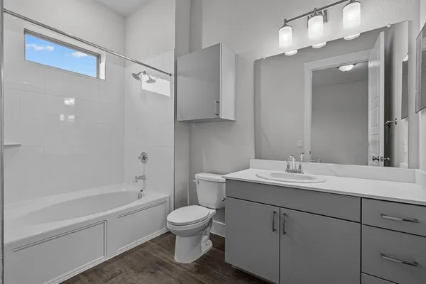 a view of empty room with wooden floor and entryway