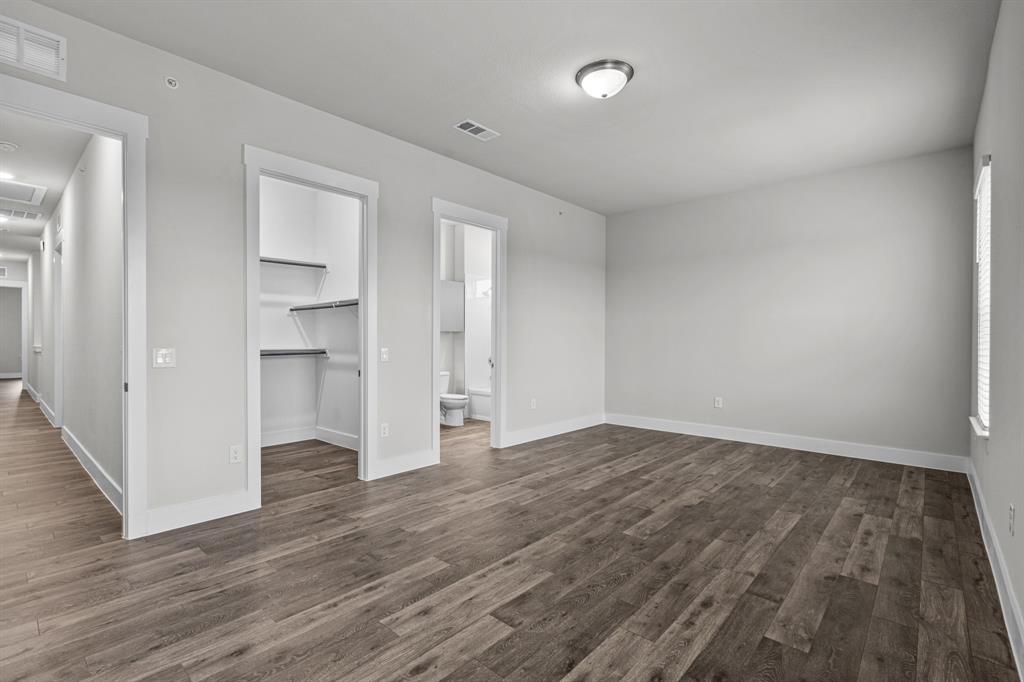 3281 Ganzer Road West, Unit 823A Denton, TX 76207 - Photo 36 of 40 a view of empty room with wooden floor and entryway