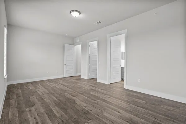 a view of walk in closet with empty racks