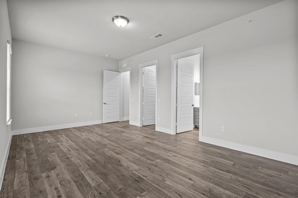 3281 Ganzer Road West, Unit 823A Denton, TX 76207 - Photo 37 of 40 a view of an empty room with wooden floor