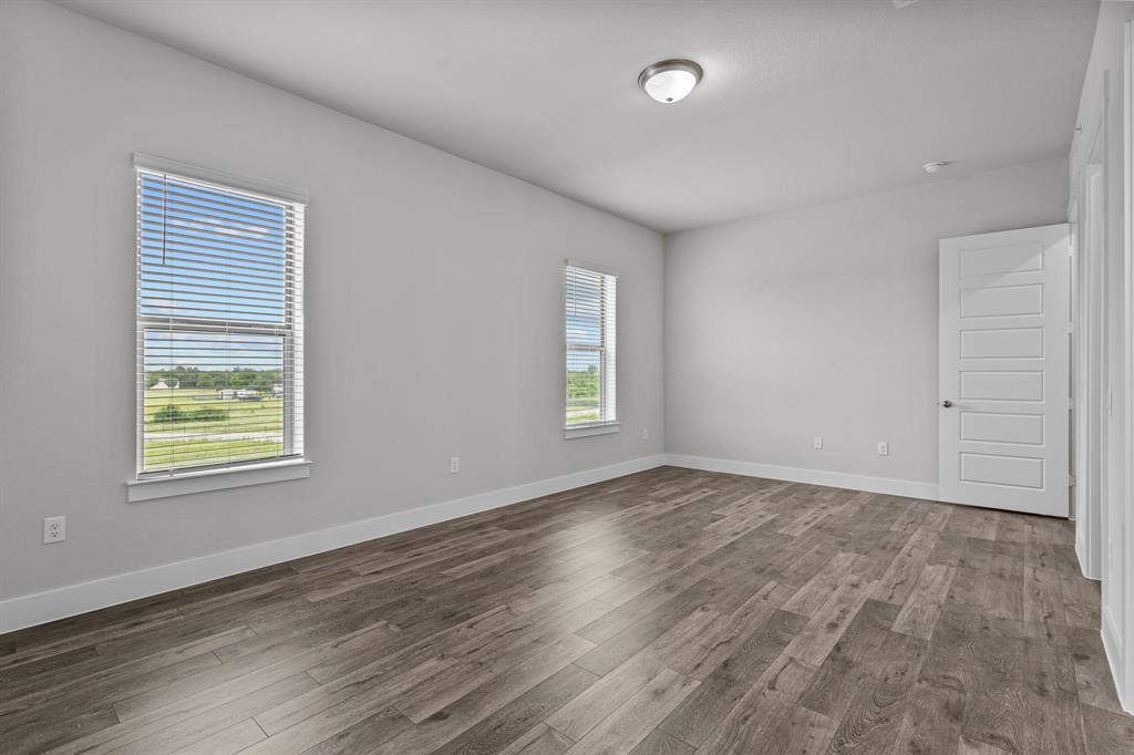 3281 Ganzer Road West, Unit 823A Denton, TX 76207 - Photo 38 of 40 an empty room with wooden floor and windows