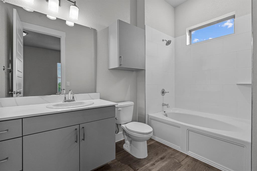 3281 Ganzer Road West, Unit 823A Denton, TX 76207 - Photo 40 of 40 a bathroom with a sink a toilet and shower