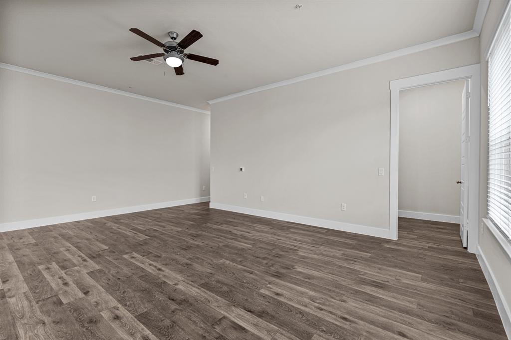 3281 Ganzer Road West, Unit 823A Denton, TX 76207 - Photo 4 of 40 a view of a room with wooden floor and a ceiling fan
