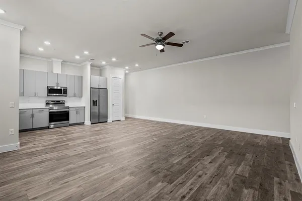 a view of a kitchen with a stove cabinets and wooden floor