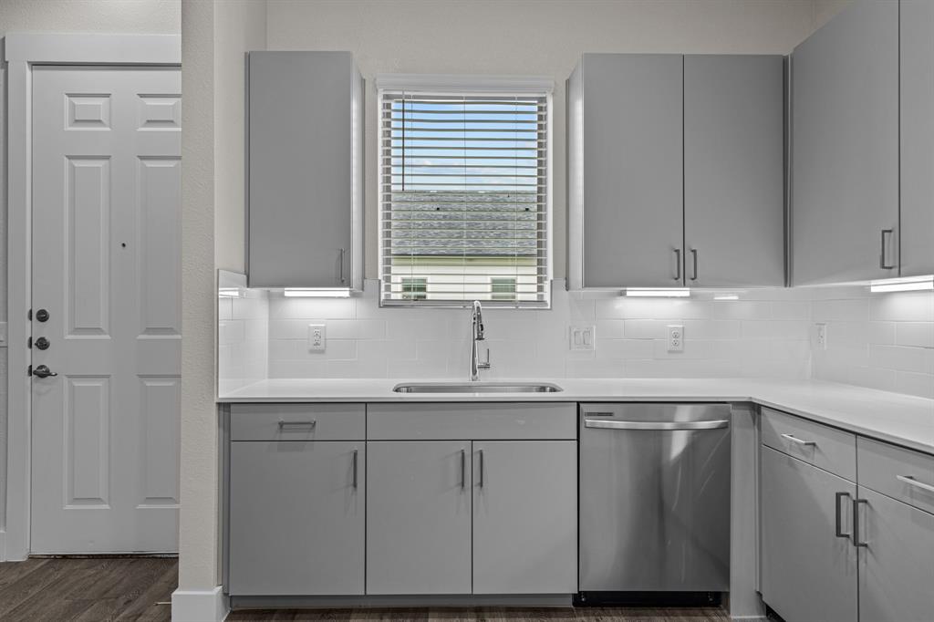 3281 Ganzer Road West, Unit 823A Denton, TX 76207 - Photo 9 of 40 a kitchen with white cabinets and a window