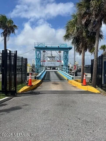 a view of swimming pool with a yard and palm trees