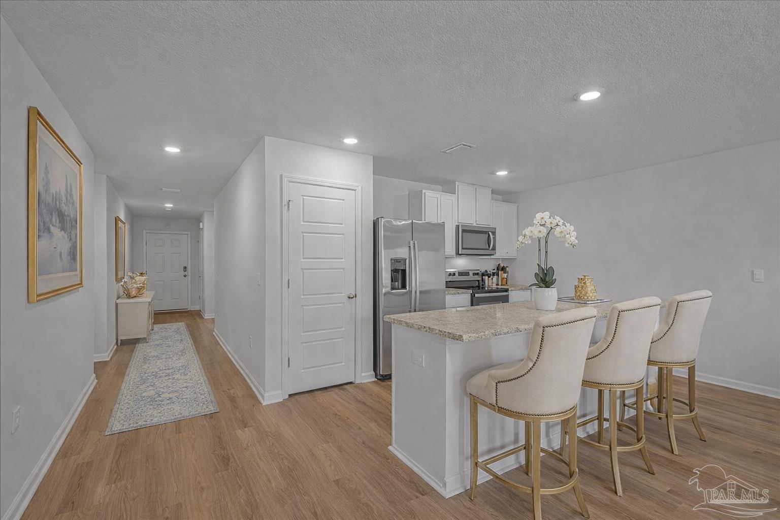 5872 Belmont Stakes Road Pensacola, FL 32526 - Photo 12 of 31 a kitchen with stainless steel appliances a sink stove and refrigerator