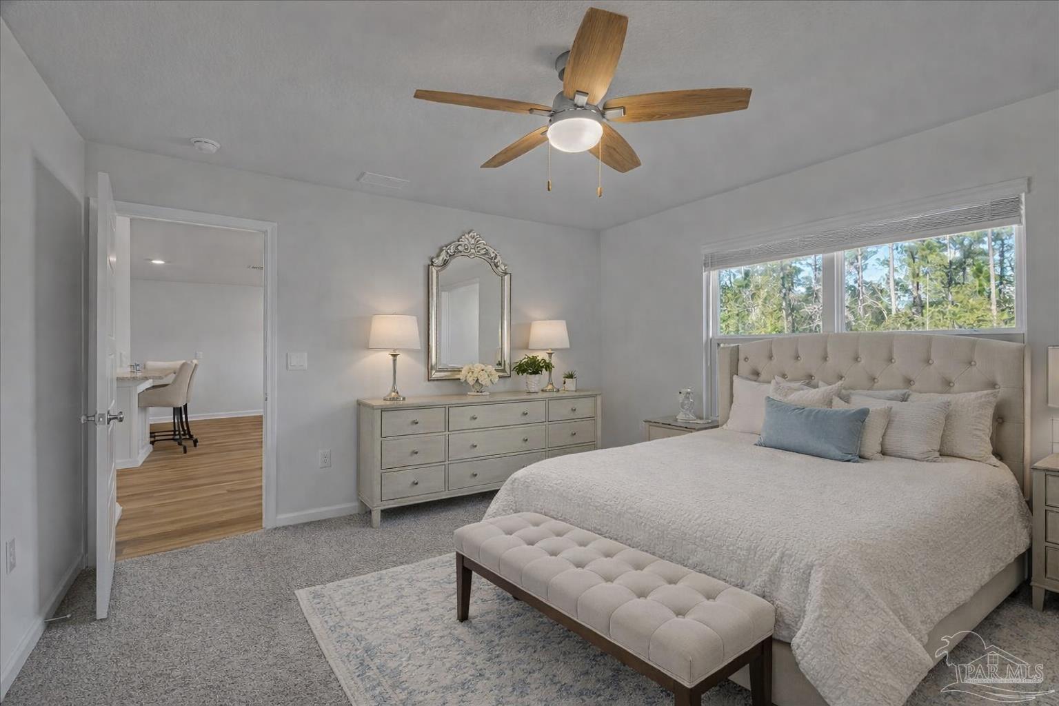 5872 Belmont Stakes Road Pensacola, FL 32526 - Photo 16 of 31 a bedroom with a bed a chandelier and dresser
