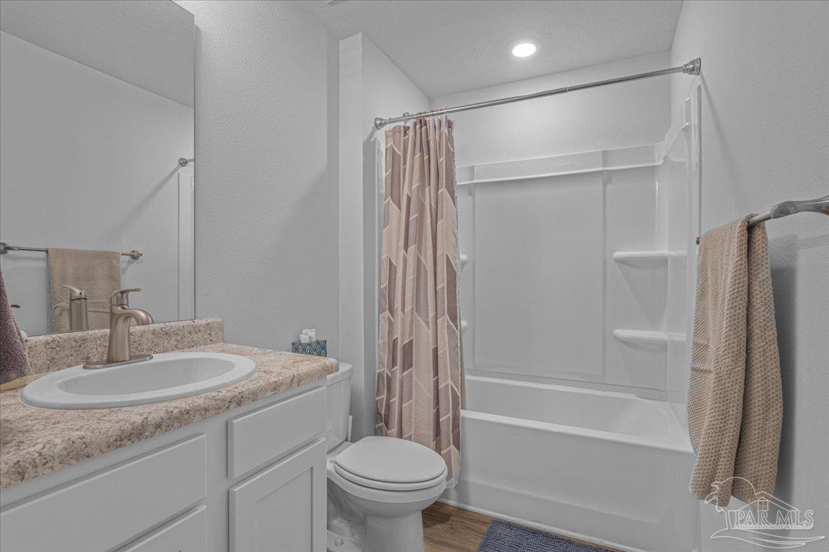 5872 Belmont Stakes Road Pensacola, FL 32526 - Photo 18 of 31 a bathroom with a granite countertop sink toilet and shower