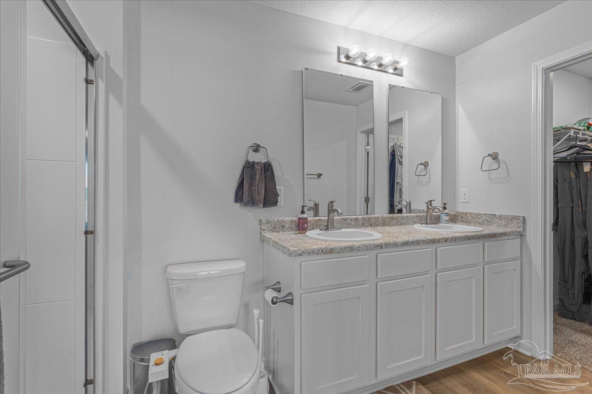 5872 Belmont Stakes Road Pensacola, FL 32526 - Photo 22 of 31 a bathroom with a granite countertop sink toilet and mirror