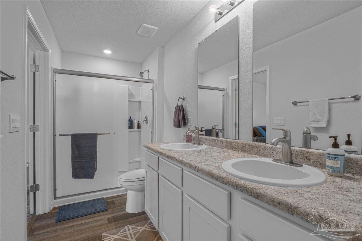 5872 Belmont Stakes Road Pensacola, FL 32526 - Photo 23 of 31 a bathroom with a sink toilet and shower