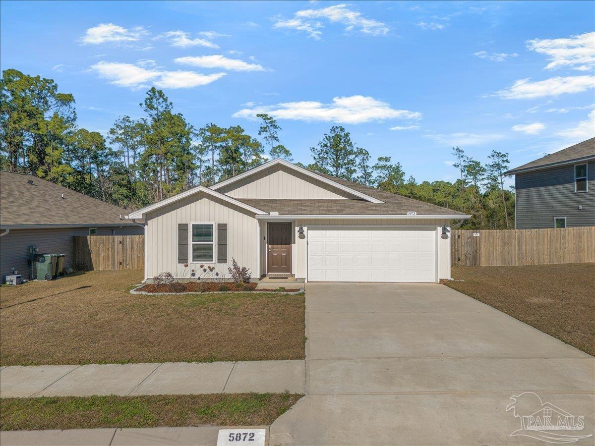 5872 Belmont Stakes Road Pensacola, FL 32526 - Photo 27 of 31 a front view of a house with a yard and garage
