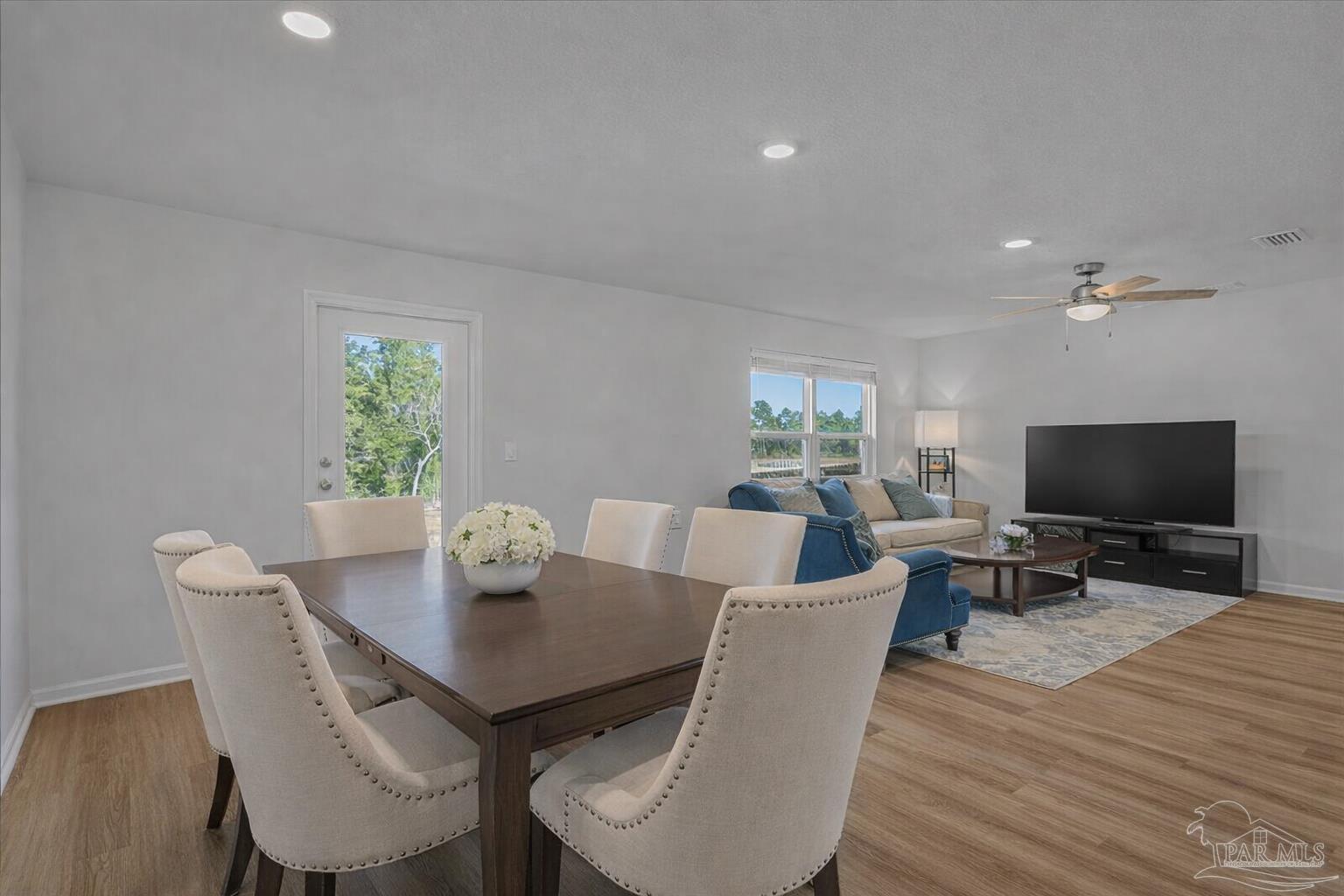 5872 Belmont Stakes Road Pensacola, FL 32526 - Photo 8 of 31 a view of a dining room with furniture and wooden floor