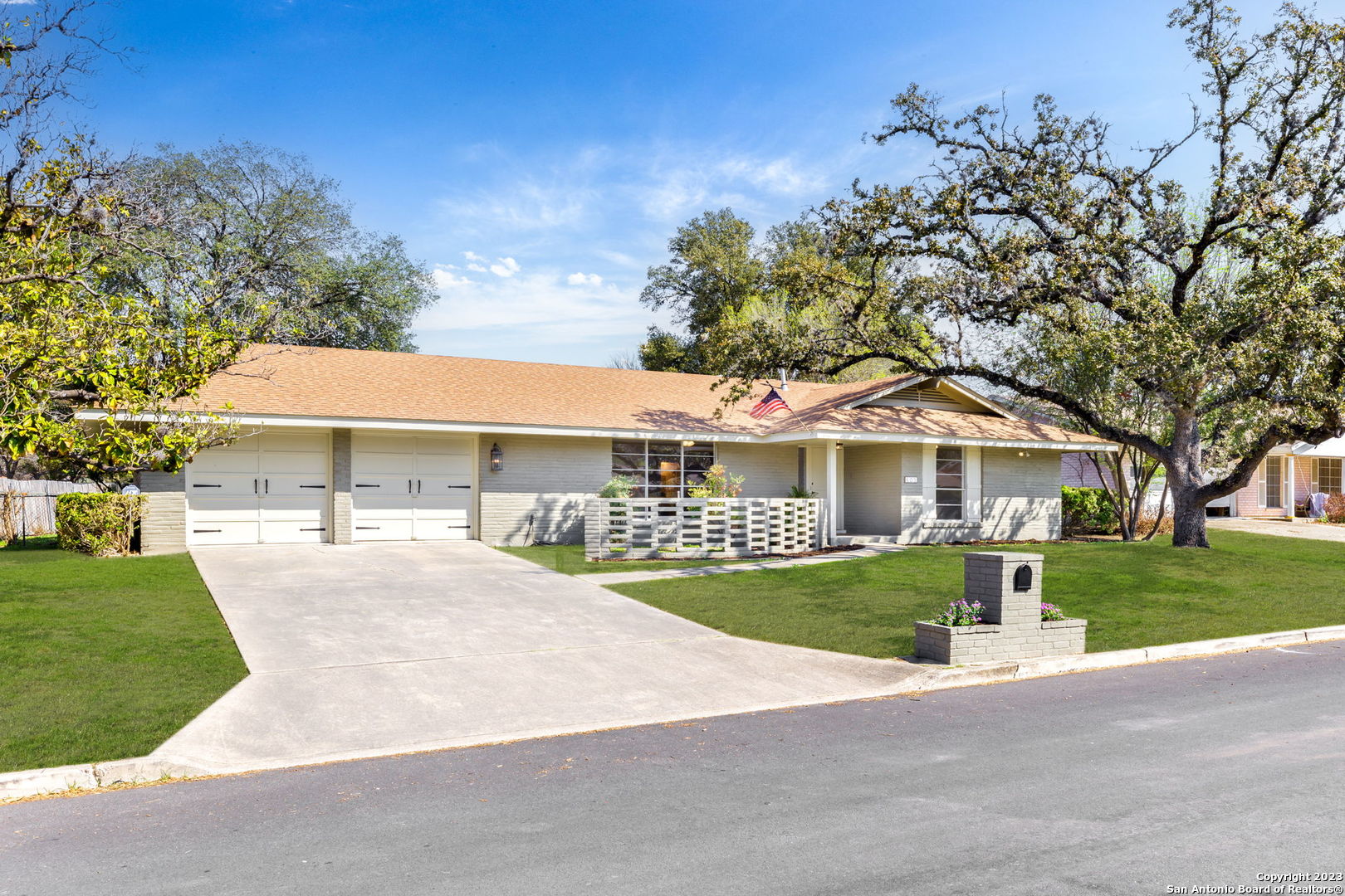 405 Winfield Boulevard Windcrest, TX 78239 - Photo 1 of 1 a front view of a house with a garden and trees
