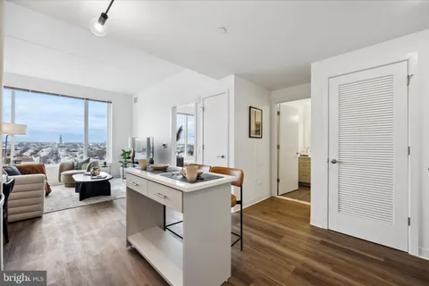 a view of kitchen with stainless steel appliances granite countertop sink stove and wooden floor