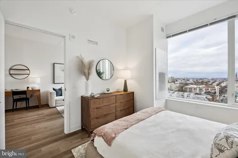 a bedroom with a large bed and a dresser