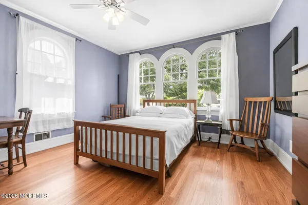 a bedroom with a bed and a large window