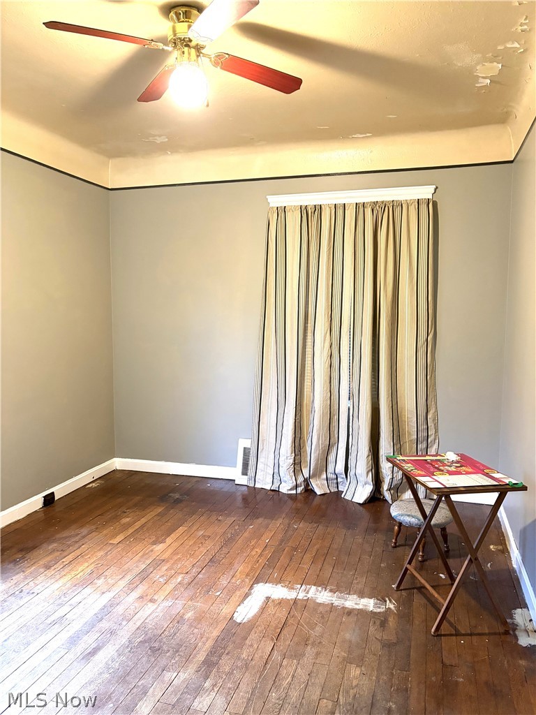 969 Evangeline Road Cleveland, OH 44110 - Photo 18 of 38 Empty room with dark wood-style floors and a ceiling fan