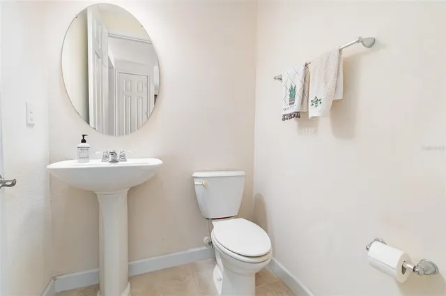 a bathroom with a sink toilet and a mirror