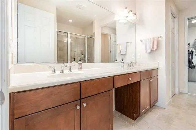 a bathroom with a double vanity sink mirror and double
