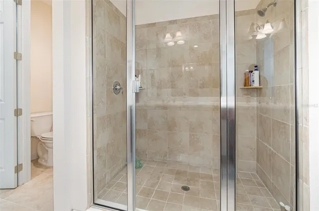 a bathroom with a glass shower door