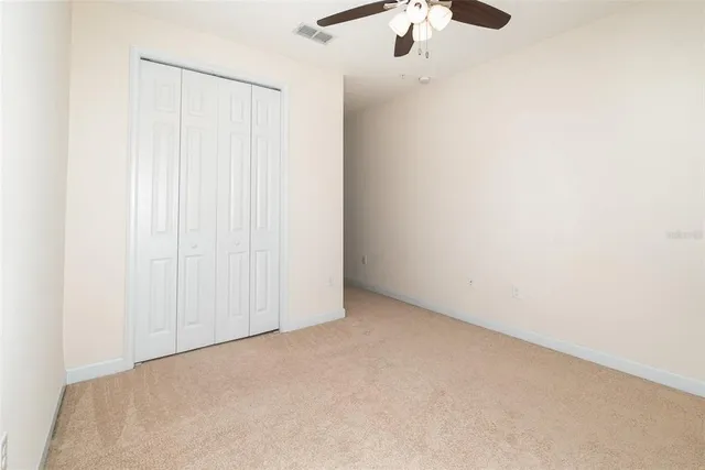 an empty room with a ceiling fan