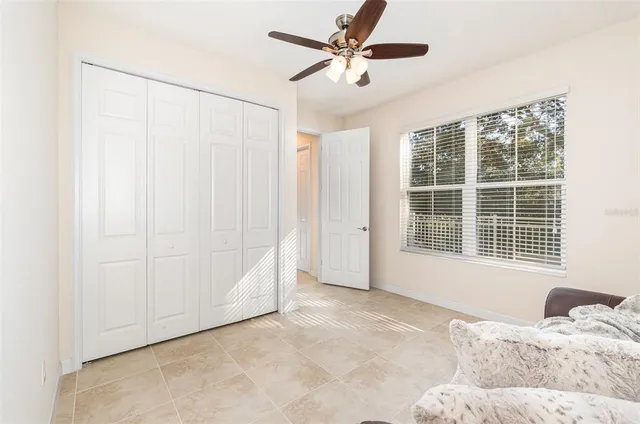a bedroom with a large bed and a large window