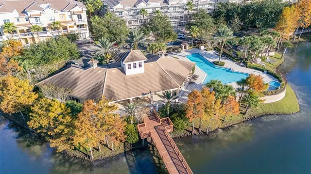 an aerial view of a house with a yard and lake view