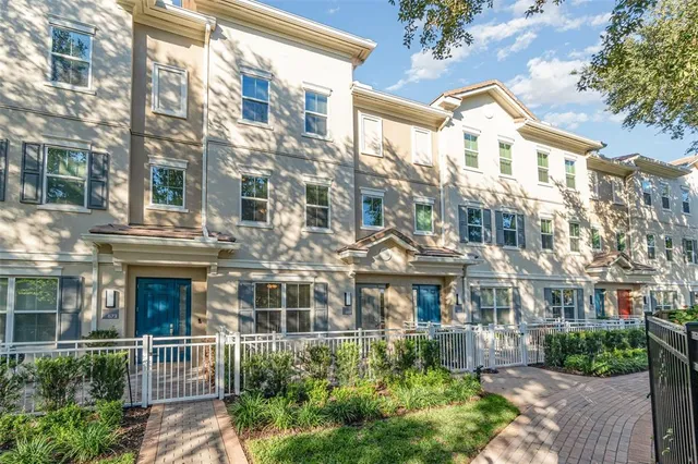 a front view of a multi story building with a yard