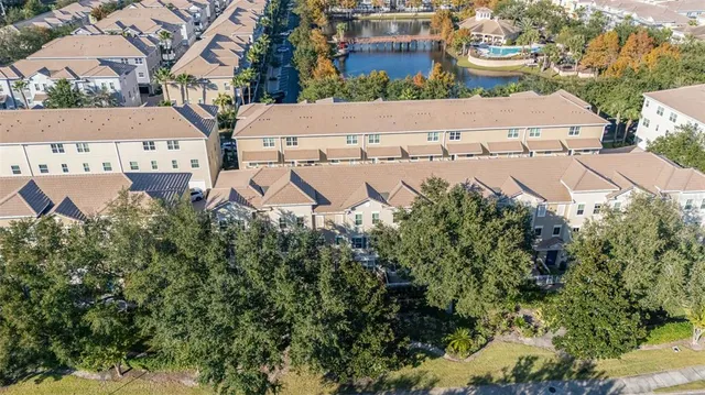 an aerial view of a house with a yard and lake view